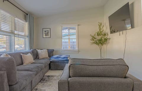 Unwind in our cozy living room after a day of exploring. Sink into the plush sofa, catch a movie on the large screen TV, and enjoy the comfortable atmosphere. Your home away from home awaits! #cozyvibes #vacationrental #homestay #relax