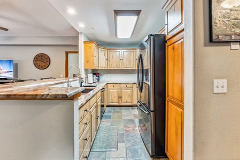 Kitchen: Drip coffee maker, Crockpot, blender, cooking utensils, tableware, high chair