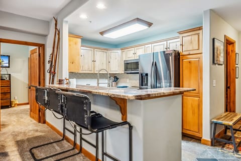 Kitchen: Drip coffee maker, Crockpot, blender, cooking utensils, tableware, high chair