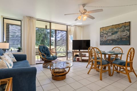 Sunlit living & dining area opening to greenery for easy lounging.