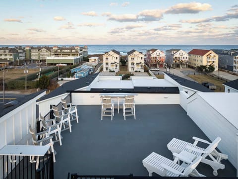 Ocean-view rooftop deck with comfortable seating for sunset views and unwinding
