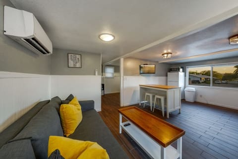 HOUSE: Living room space with view of kitchen and front of house