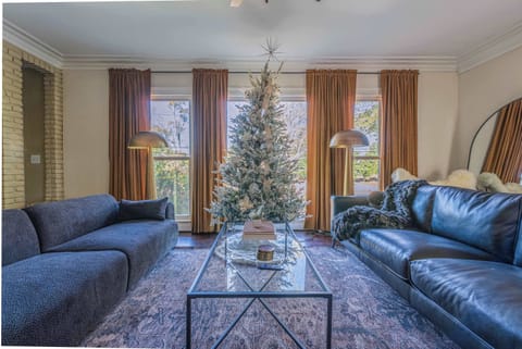 "Sink into the plush sofas of this beautifully appointed living room. Featuring a striking stone display fireplace, ample natural light, and a cozy atmosphere, it's the perfect place to unwind after a day of exploring."

