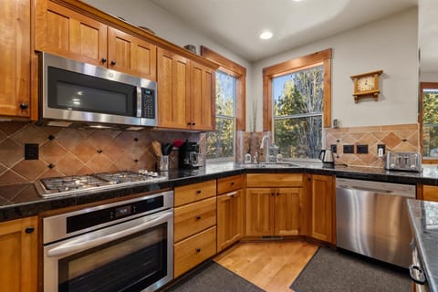 The warm, open kitchen offers ample space & every home comfort