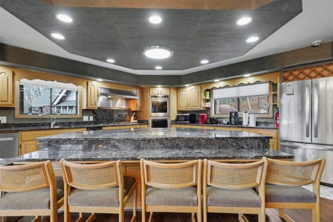 Large island kitchen with seating, double ovens, and prep space for groups