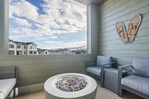 Sip your beverage of choice in the mountain air on this private balcony with fire pit.