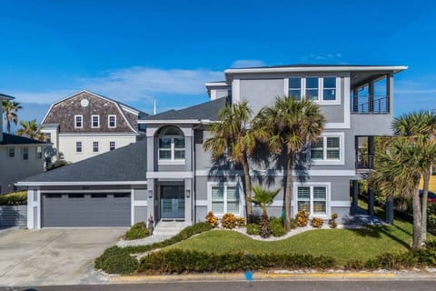 Private beach home exterior with modern coastal architecture and covered porches