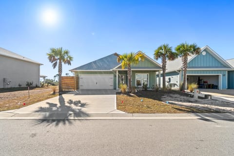 Charming coastal home with tropical palm trees and modern design in a quiet residential neighborhood.