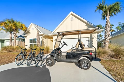 Modern beachside home with complimentary golf cart and bikes for easy exploration of the tropical resort community.