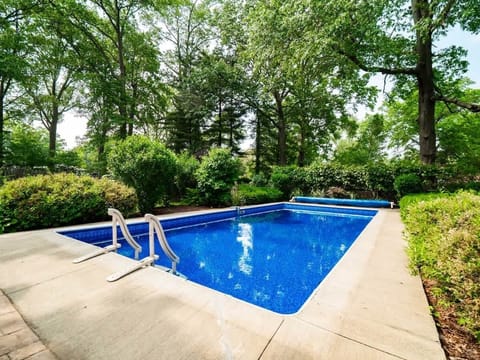 Refreshing outdoor pool surrounded by lush greenery for a peaceful swim