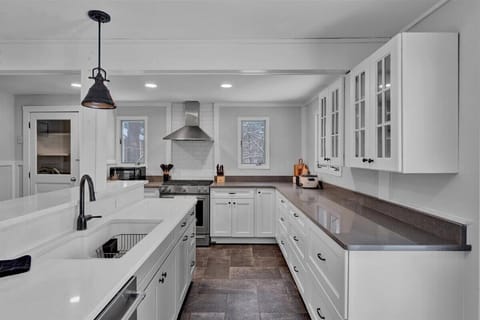 Farmhouse Kitchen with White Cabinets & Large Countertops