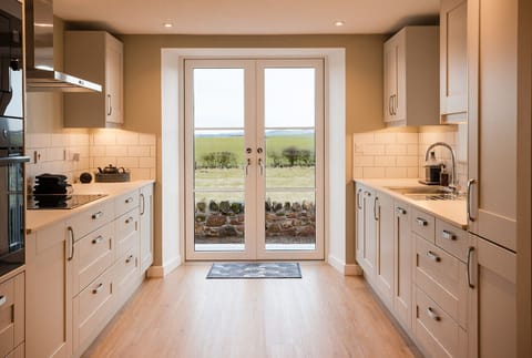 Kitchen with views to fields and walk out to hot tub