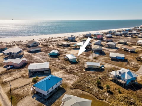 Aerial view showcasing the beachfront community with pristine sandy shores and Gulf waters stretching to the horizon.