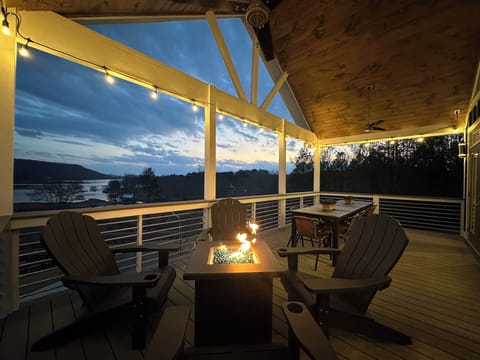 Main level balcony accompanied by a firepit & large outdoor dining table!