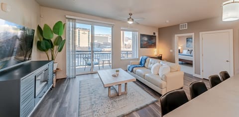 Beautifully designed living room. 75` TV. Electric fireplace. Leather sofa and amazing views of mountains and city skyline.