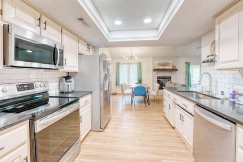 A symphony of stainless steel and soft neutrals. This kitchen whispers of comfort and modern ease. 