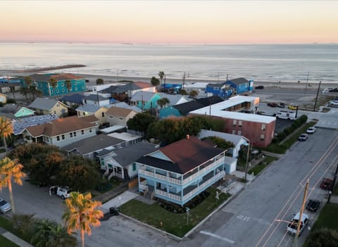 The Lookout at R½ on the Galveston Seawall — the beach is a 2-minute walk from your private top-floor wraparound deck. Golden hour over the Gulf.