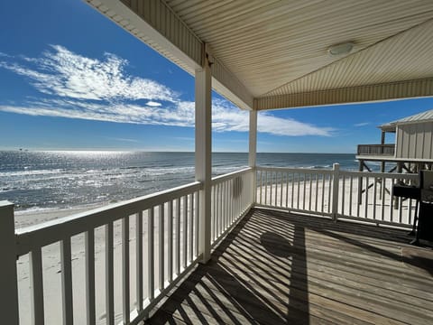 Your private oceanfront balcony overlooks pristine sandy shores and endless blue waters, perfect for morning coffee or sunset relaxation.