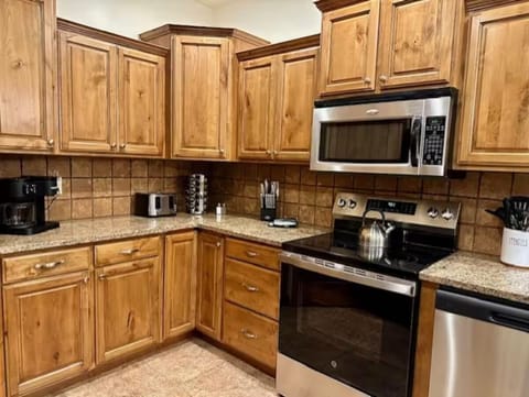 Kitchen with dual coffee maker, toaster, crockpot, blender, fully stocked dishes