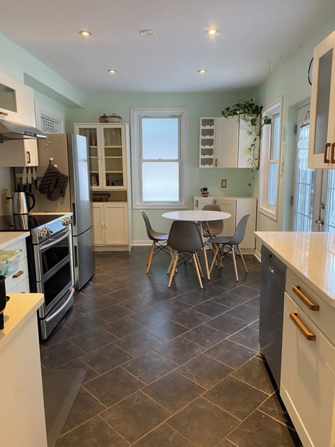 Beautiful, light-filled modern kitchen with new appliances off porch & backyard.