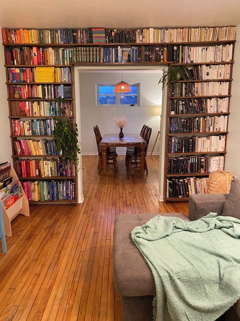 Floor-to-ceiling library wall in the Living Room. Grab one & curl up with it!