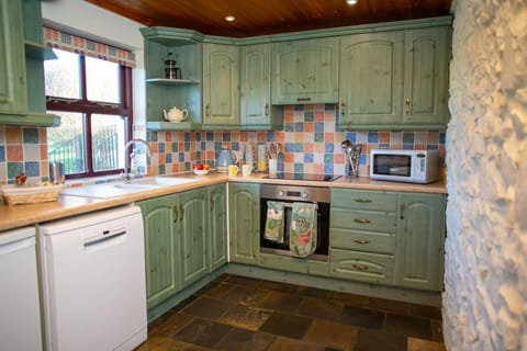 Kitchen with electric oven and hob, microwave, dishwasher and kettle