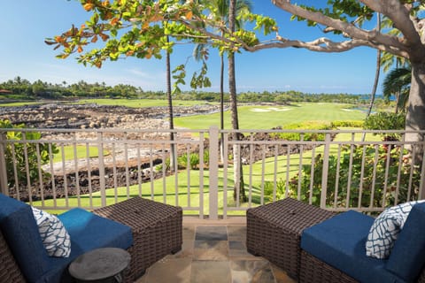 Outdoor seating for two on the Primary Bedroom lanai overlooking lush landscapes and serene golf course vistas.