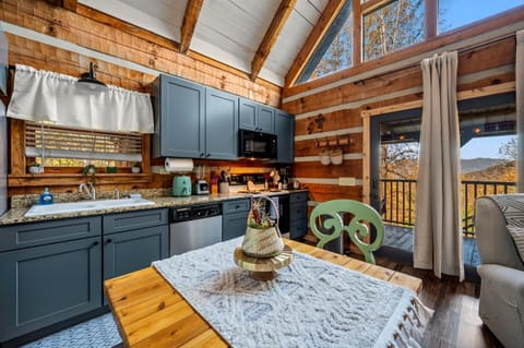 Fully equipped cabin kitchen, perfect for preparing meals in a rustic setting.