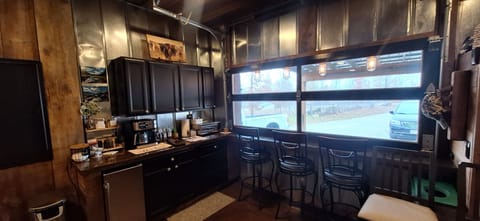 Bar in rec room. Garage door opens to the outside.
