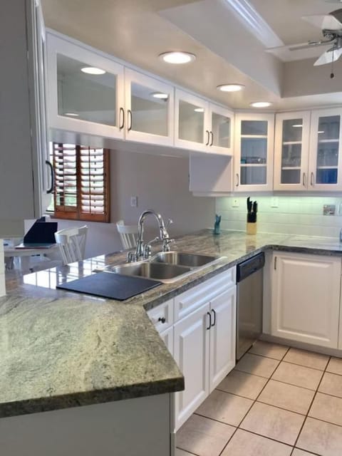 Gourmet Kitchen: The chef-inspired kitchen features sleek granite countertops, stainless steel appliances, a wine fridge, and a spacious bar area—perfect for preparing meals or enjoying drinks with family and friends.