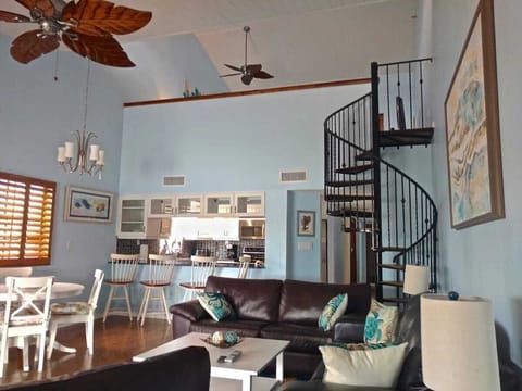 The spacious living room features soaring cathedral ceilings, a pullout queen memory foam sofa, and a second cozy sofa. Enjoy scenic views of the Intercoastal Waterway from the balcony, where you can watch dolphins, manatees, and boat traffic.