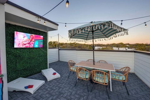 Enjoy the rooftop TV or play cornhole with friends! - The Pink Stetson - Nashville, TN