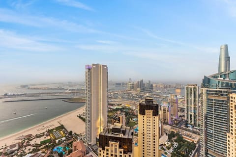 Panoramic city and waterfront views from a modern high-rise in a vibrant coastal district