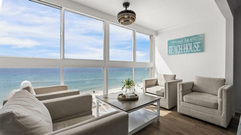 Edgewater West 72 - A sunroom with floor-to-ceiling windows showcasing Gulf views—perfect for morning coffee or unwinding as the sky shifts over the water.