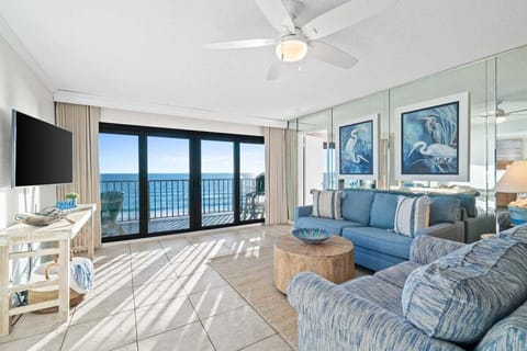 The living room offers a bright, welcoming space with a comfortable sleeper sofa perfect for extra guests.