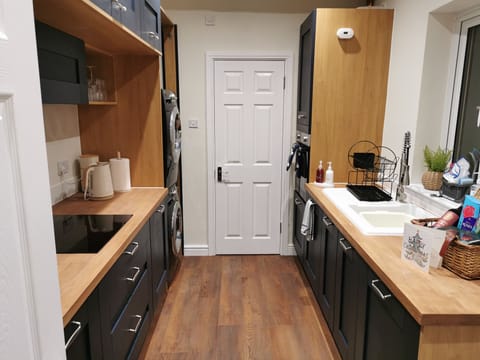 Galley kitchen leading to shower room