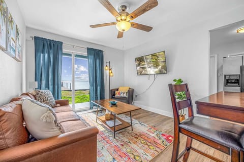 Relax in the cozy living room with waterfront views through sliding glass doors.
