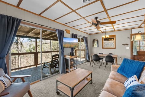 The living room includes a large Smart TV, an electric fireplace and plenty of comfortable furniture.