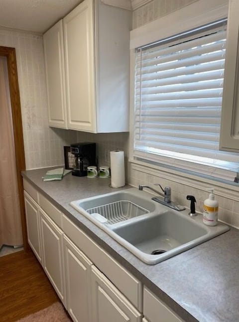Kitchen with stocked cabinets and coffee maker