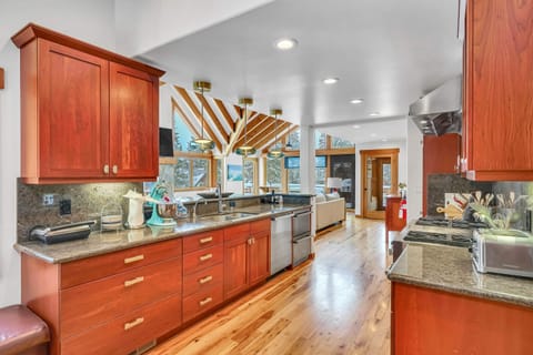 Kitchen: Drip coffee maker, Nespresso, Crockpot, blender, stand mixer, 2 sinks, food-warming drawers, 9-burner stove with griddle, double oven, sub-zero fridge, cooking utensils, tableware