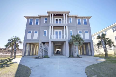 Spacious two-story beach house in Gulf Shores, elevated on sturdy stilts for stunning views and added safety. This large coastal retreat offers plenty of room for family and friends, with open living areas breezy porches and the beach just steps away