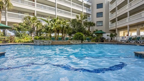 Relax in the hot tub or pool with loungers nearby.