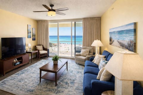 Spacious beachfront living room with plenty of seating and balcony access!