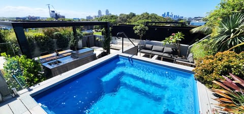 Large private rooftop with pool, pergola, outdoor dining table, BBQ + sink
