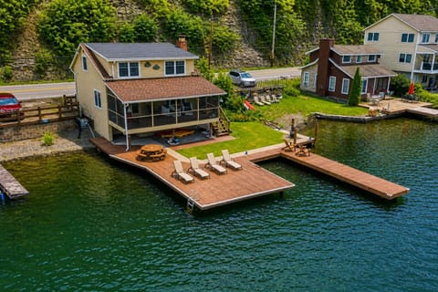 Nestled at the edge of a serene lake, this charming dock features a row of inviting, comfortable chairs, perfect for relaxing and enjoying the peaceful surroundings. The chairs, crafted from weather-resistant materials, are designed for comfort with 