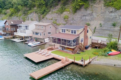 Nestled at the edge of a serene lake, this charming dock features a row of inviting, comfortable chairs, perfect for relaxing and enjoying the peaceful surroundings. The chairs, crafted from weather-resistant materials, are designed for comfort with 