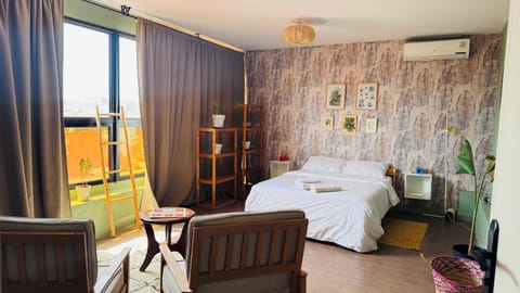 Spacious queen bedroom with panoramic Marrakech and mountain views.