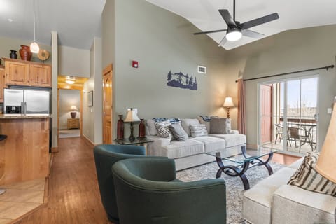 Vacation Rentals in Park City at Bear Hollow Lodges 1403: Living room with Queen sofa bed, gas fireplace, and private balcony access