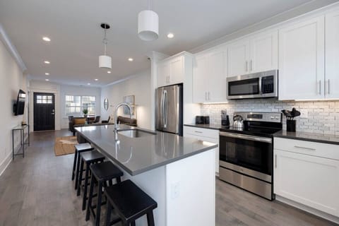 Modern kitchen with stainless steel appliances.