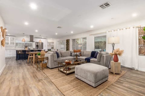 Relax in the spacious living room with a comfortable sofa, perfect for unwinding after a day of exploration.